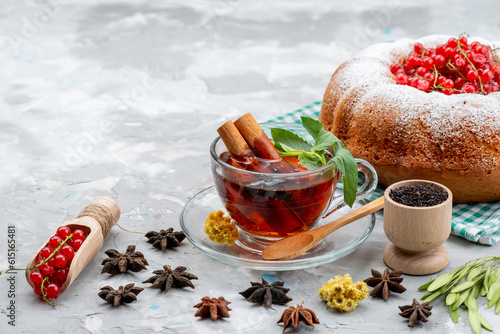 Фотография a front view fresh red cranberries sour and mellow with round cake tea and cinna