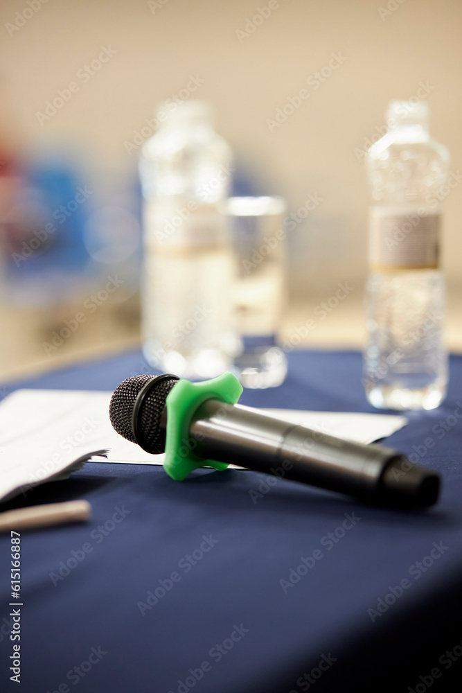 the speaker's microphone lies on the table during a conference, forum. microphone lying on the table, ready to use. vertical orientation image