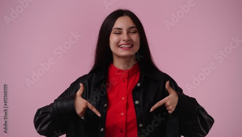 4k video of one girl who pointing down over pink background.