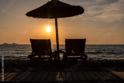 Obraz na płótnie Sun loungers and parasol in sunset on Paros island, Greece w salonie