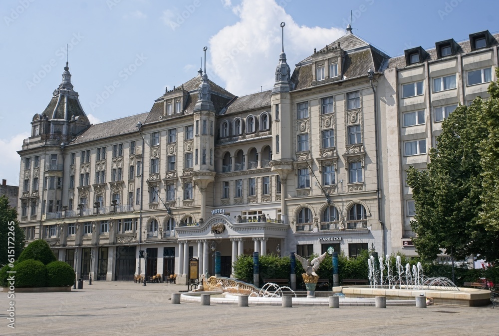 Debrecen, Hungary - Jun 18, 2023: A walking in the center of Debrecen city in northeastern Hungary in a sunny spring day. Grand Hotel Aranybika. Selective focus.