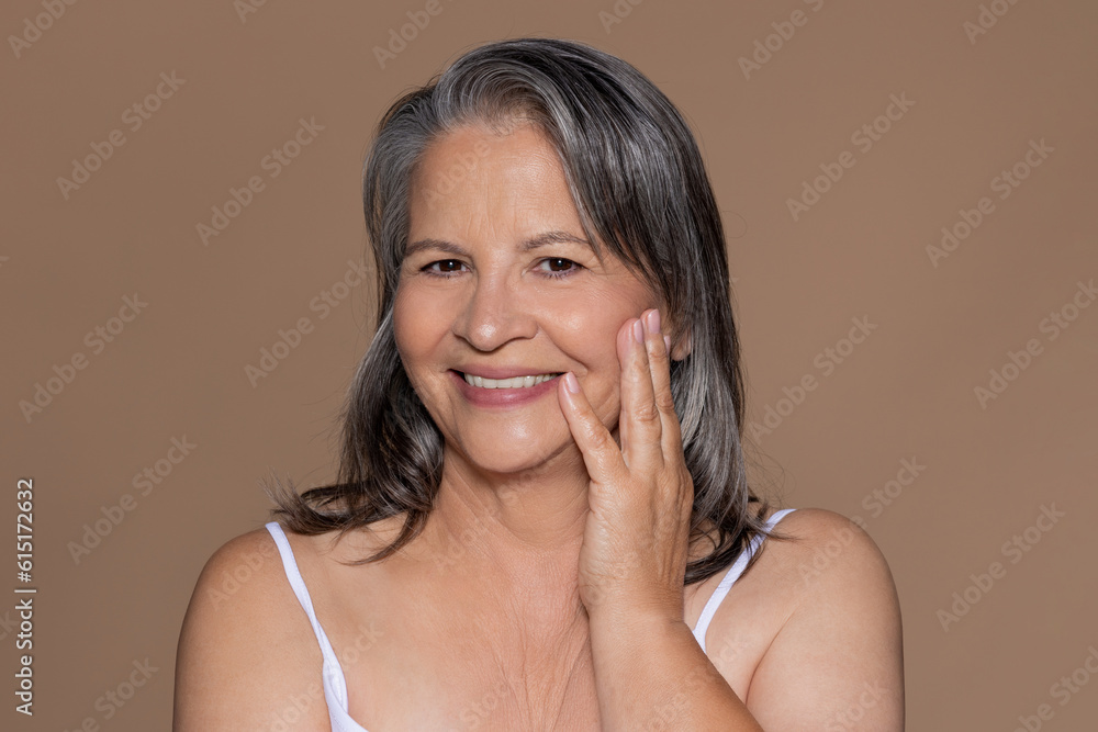 Smiling european senior gray haired woman enjoy perfect skin, good result after beauty therapy Smiling european senior gray haired woman enjoy perfect skin, good result after beauty therapy