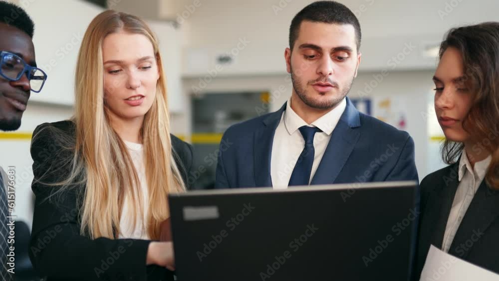Businessman shows data for briefing on laptop. International business partners discuss project results on meeting in office. Multiethnic corporate team planning. People brainstorming on briefing. Businessman shows data for briefing on laptop. International business partners discuss project results on meeting in office. Multiethnic corporate team planning. People brainstorming on briefing.
