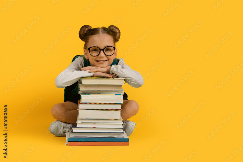 Back To School. Cute Little Schoolgirl Leaning At Book Stack And Smiling Back To School. Cute Little Schoolgirl Leaning At Book Stack And Smiling