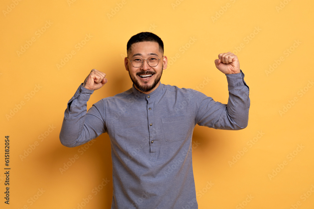 Big Luck. Overjoyed Young Asian Man Celebrating Success With Raised Fists Big Luck. Overjoyed Young Asian Man Celebrating Success With Raised Fists