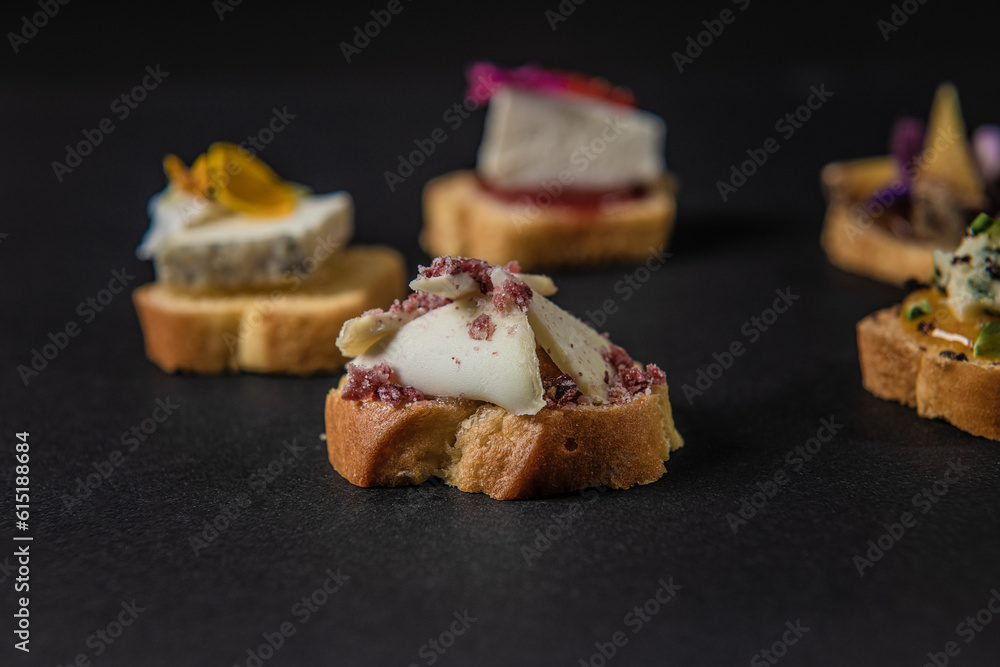 focus on various gastronomic appetizers on a black background focus on various gastronomic appetizers on a black background