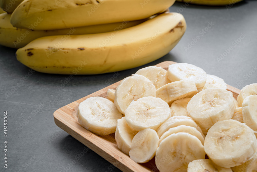 Banana slices and banana curls on the stone table. Banana slices and banana curls on the stone table.