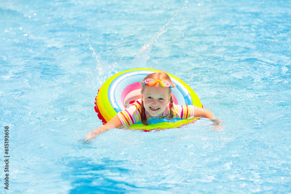 Child in swimming pool. Kids swim. Water play.