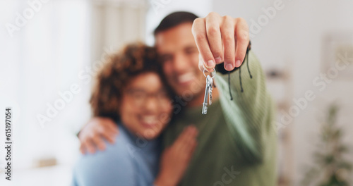 Hand, keys and a home owner couple proud of their real estate property investment or purchase. House, mortgage or beginning with a blurred background man and woman together in their new apartment photo
