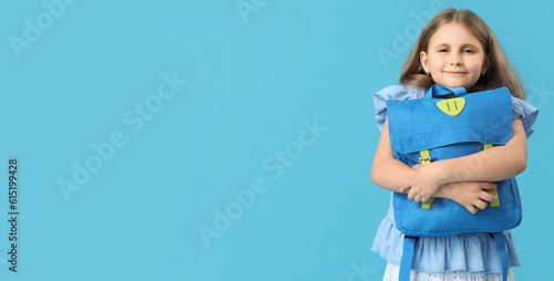 Little girl with school bac...