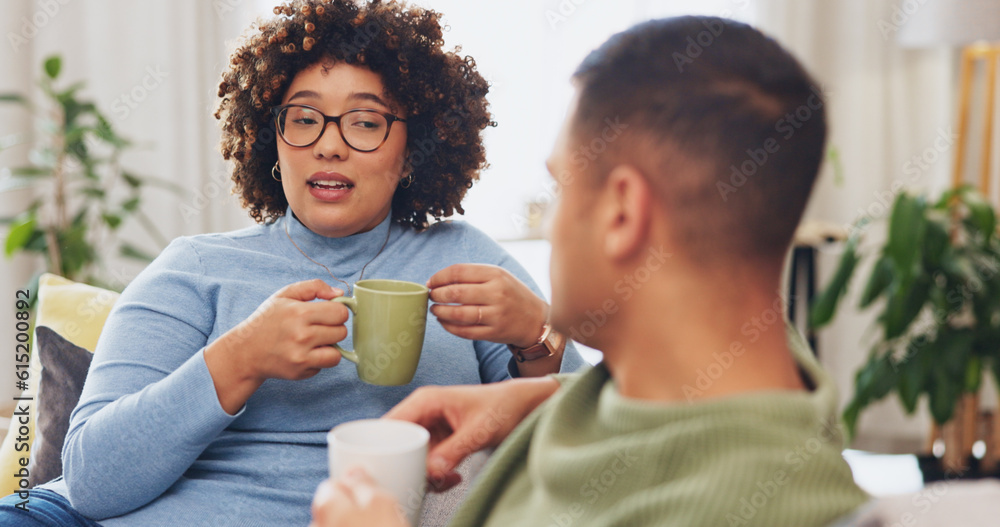Interracial happy couple, conversation and coffee on sofa for morning bonding in living room together. Discussion, woman and man on couch with tea, quality time to relax, talk and plan day in lounge. Interracial happy couple, conversation and coffee on sofa for morning bonding in living room together. Discussion, woman and man on couch with tea, quality time to relax, talk and plan day in lounge.