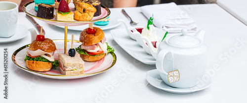 Wallpaper Mural Afternoon tea and sweets on the table,English afternoon tea in garden cafe: scones with cream and strawberry jam with various sandwiches on selective focus background. Torontodigital.ca