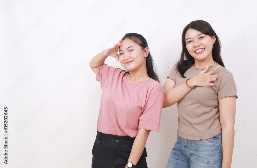 Close up portrait of two pretty asian sisters smiling on camera. Isolated on white with copyspace Close up portrait of two pretty asian sisters smiling on camera. Isolated on white with copyspace