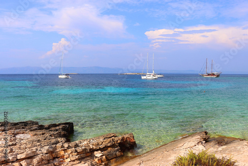 Beautiful wild beach and sailing boats on Proizd, small island near island Korcula, Croatia.  photo