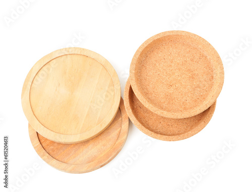 Wooden kitchen boards and cork plates on white background
