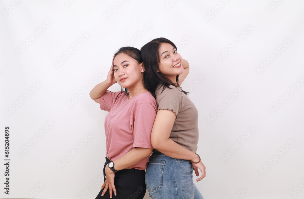 Two pretty woman standing back to back on white background. Friendship concept Two pretty woman standing back to back on white background. Friendship concept