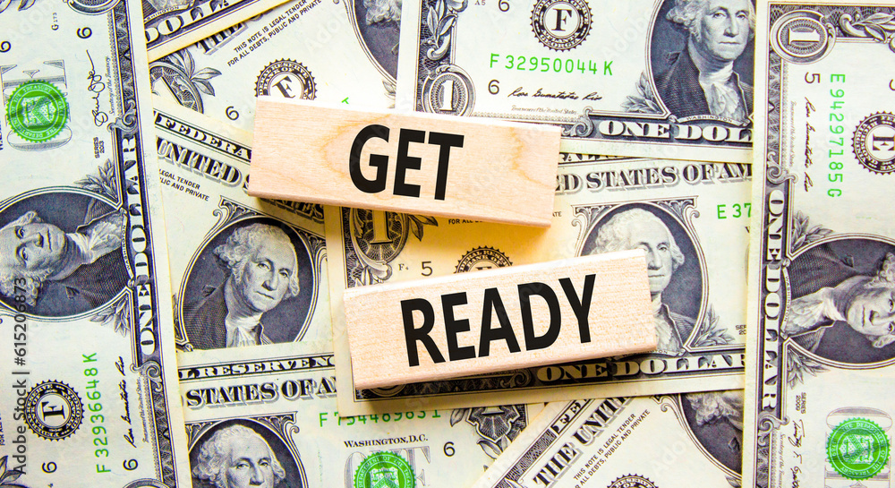 Get ready symbol. Concept words Get ready on wooden blocks on a beautiful background from dollar bills. Dollar bills. Business, support, motivation and get ready concept. Copy space.