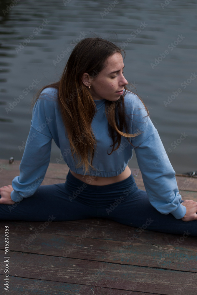 Young girl is doing yoga outdoors Young girl is doing yoga outdoors
