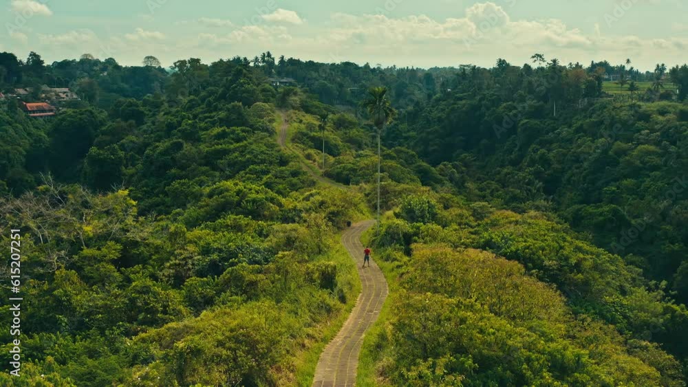 Campuhan Ridge Walk is beautiful travel destination in Ubud with scenery walking trail surrounded picturesque hills overgrown with tropical rainforest and rice terraces Bali, Indonesia 4K Aerial view Campuhan Ridge Walk is beautiful travel destination in Ubud with scenery walking trail surrounded picturesque hills overgrown with tropical rainforest and rice terraces Bali, Indonesia 4K Aerial view