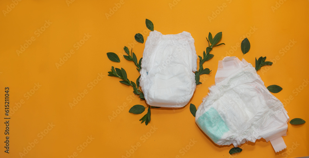 Biodegradable diapers. Ecofriendly and disposable diaper on an orange