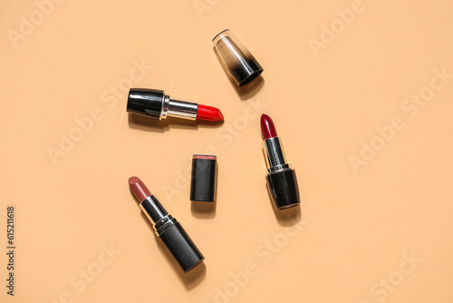 Different lipsticks on beige background