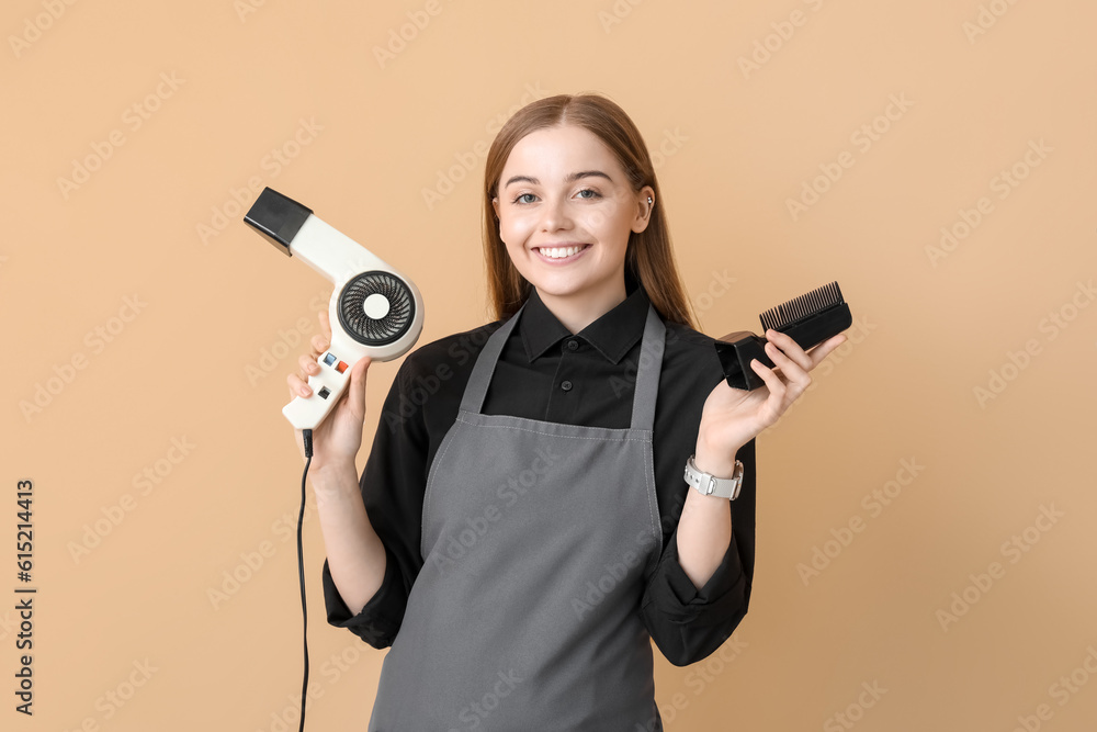 Female hairdresser with dryer on beige background Female hairdresser with dryer on beige background