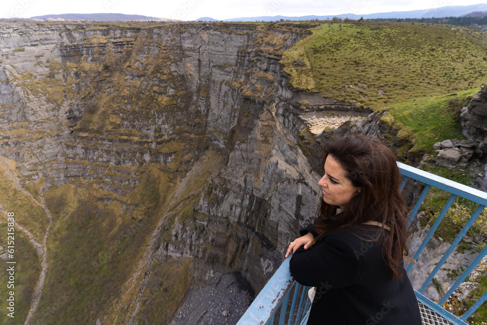 A woman enjoying the landscape from the viewpoint of Salto del Nervión in the Basque Country, Spain A woman enjoying the landscape from the viewpoint of Salto del Nervión in the Basque Country, Spain