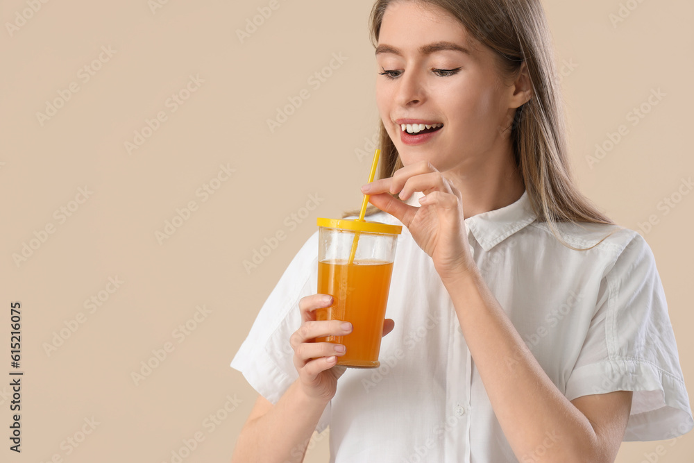 Young woman with glass of carrot juice on beige background, closeup Young woman with glass of carrot juice on beige background, closeup