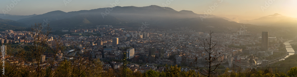Panoramic view of the city of Bilbao from Mount Artxanda at sunset with a light mist on the horizon