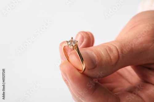 Man with golden engagement ring on white background, closeup