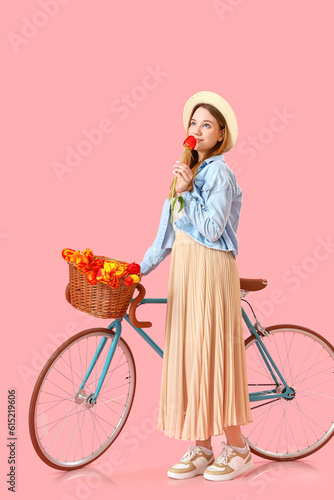 Young woman with bicycle an...