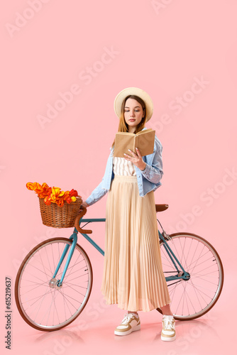 Young woman with bicycle on...