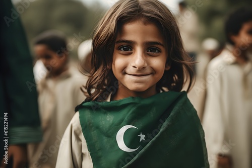 Portrait of a boy holding a Pakistan flag in his hand outdoors photo