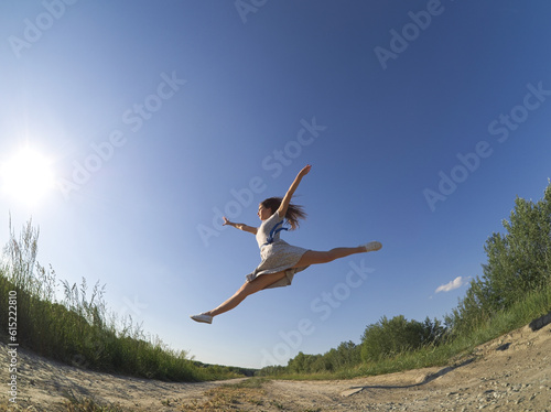 Young Dancer Jumping in a Floral Summer Dress
