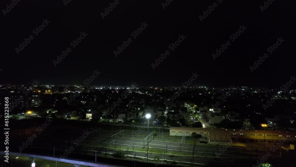 slow aerial drone shot flying forward at night with lightning flashes lighting dark thuder clouds over cityscape with small lit densely populated houses in jaipur slow aerial drone shot flying forward at night with lightning flashes lighting dark thuder clouds over cityscape with small lit densely populated houses in jaipur