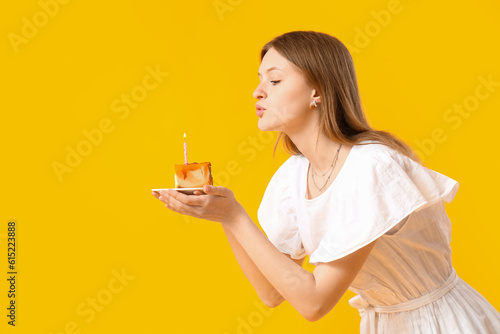 Pretty young woman blowing ...