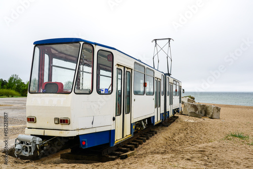 A used white electric tram car on the shore of the Baltic Sea for setting up a cafe, tram as a cafe