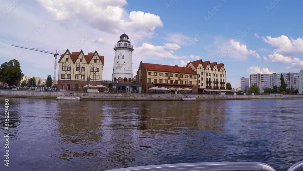 Water excursions along Pregola River through bridges past fish village, Ferry cruising, tourist ship sails on river Pregola past Kant Island, shooting from boat, Kaliningrad, Russia - June 17, 2017 Water excursions along Pregola River through bridges past fish village, Ferry cruising, tourist ship sails on river Pregola past Kant Island, shooting from boat, Kaliningrad, Russia - June 17, 2017
