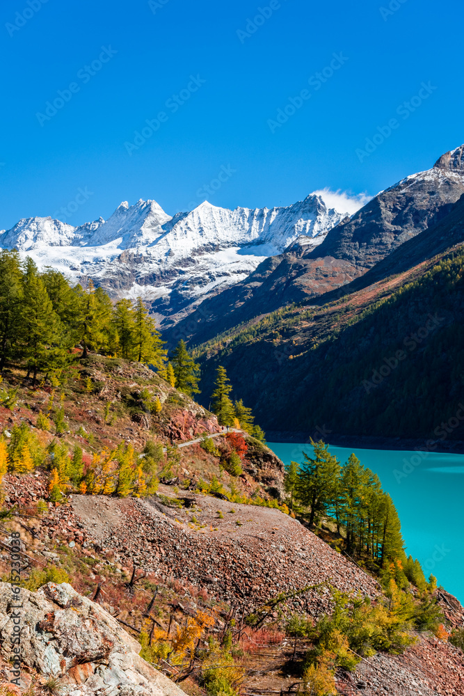 Autumnal landscape of the Lake Place Moulin, an artificial glacial lake with turquoise water in the italian Alps, on the border with Switzerland Autumnal landscape of the Lake Place Moulin, an artificial glacial lake with turquoise water in the italian Alps, on the border with Switzerland