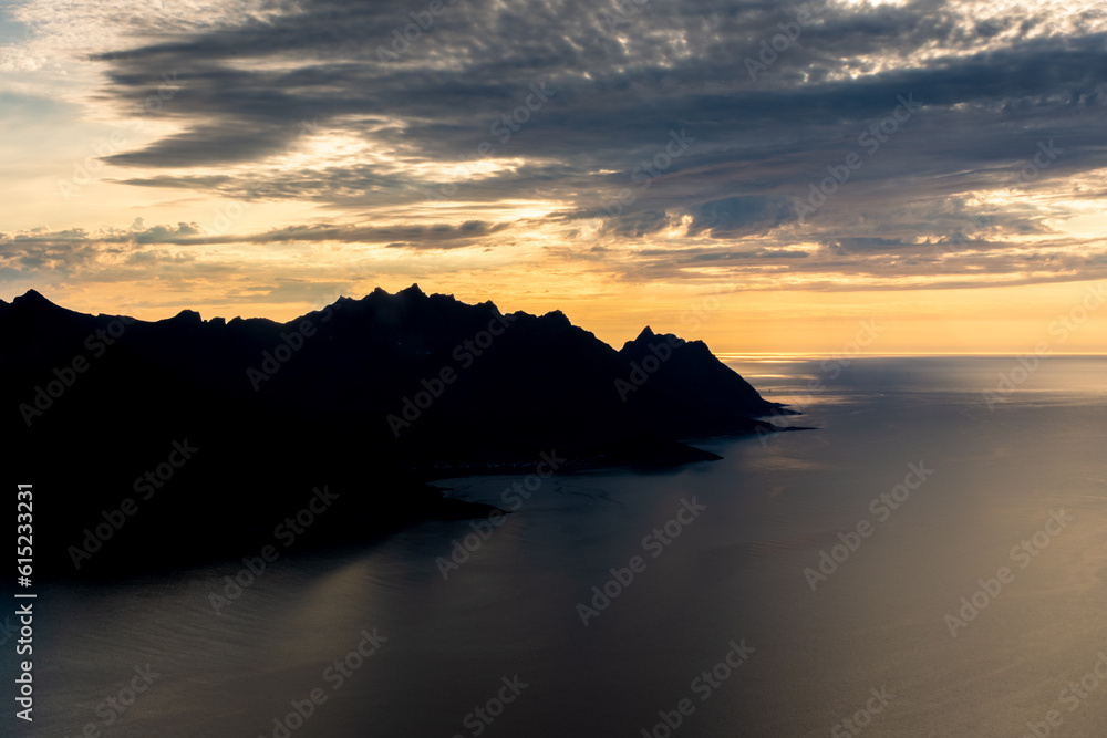 Sunset over the Devil's Teeth mountains of Senja Island and the Atlantic Ocean.  View from Hesten Mount, Norway