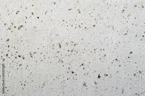 Texture of a gray concrete wall with small depressions