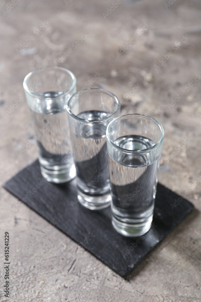 Glasses of vodka on grey background Glasses of vodka on grey background