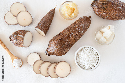 Cassava root on white background with tapioca pearls photo