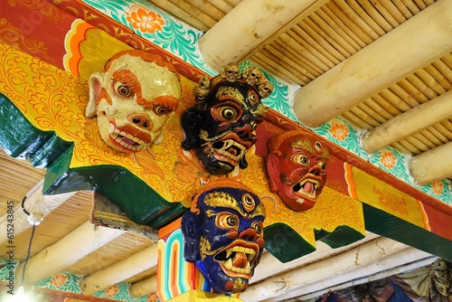 Colorful Tibetan Dancing Masks hang gracefully from a monastery column in Likir Monastery, Ladakh, Indian Himalayas.  photo