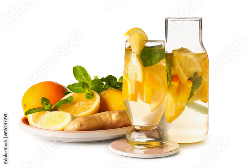 Glass and bottle of infused water with lemon on white background