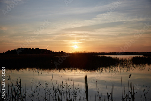 Fototapeta Naklejka Na Ścianę i Meble -  A beautiful sunset on a lake, selective focus