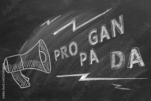 Propaganda and fake news concept. Illustration on blackboard. A megaphone with the word propaganda. Misinformation and counterinformation concept. photo