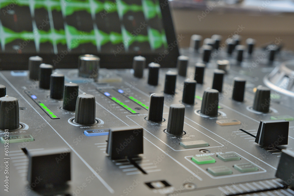 Close up of modern Dj console with monitor. LEDs, knobs, faders and sliders. Waveforms in the background. Digital turntables. Close up of modern Dj console with monitor. LEDs, knobs, faders and sliders. Waveforms in the background. Digital turntables.
