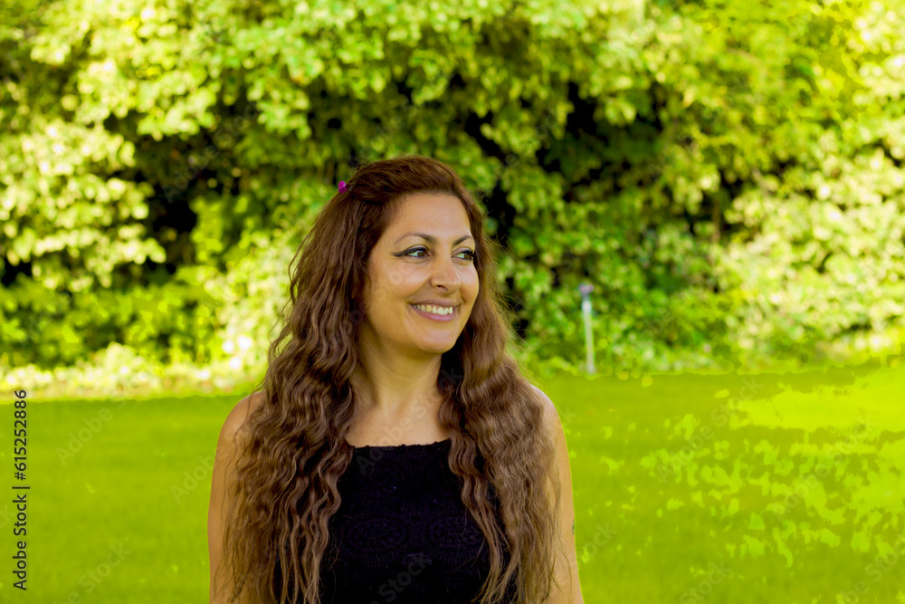 portrait of a beautiful woman in the green garden with flowers portrait of a beautiful woman in the green garden with flowers