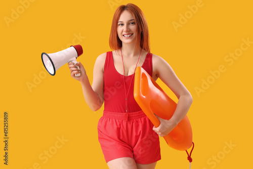 Female lifeguard with rescue buoy and megaphone on yellow background